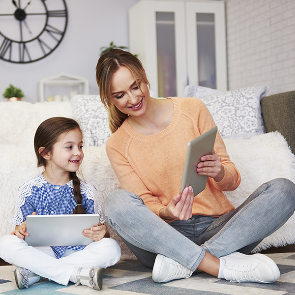 Mom and her child looking at digital tablet